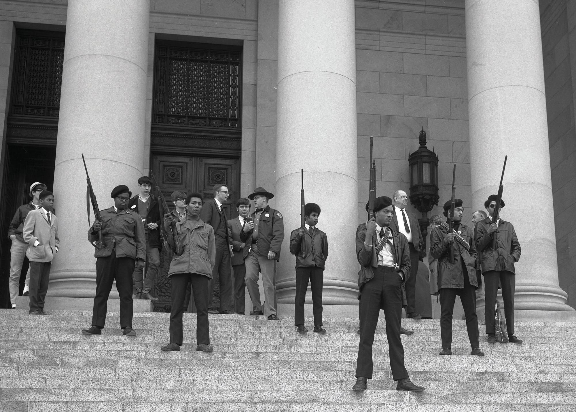 Armed members of the Seattle chapter of the Black Panther Party stand on the steps of the state capitol in Olympia, Washington, 1969