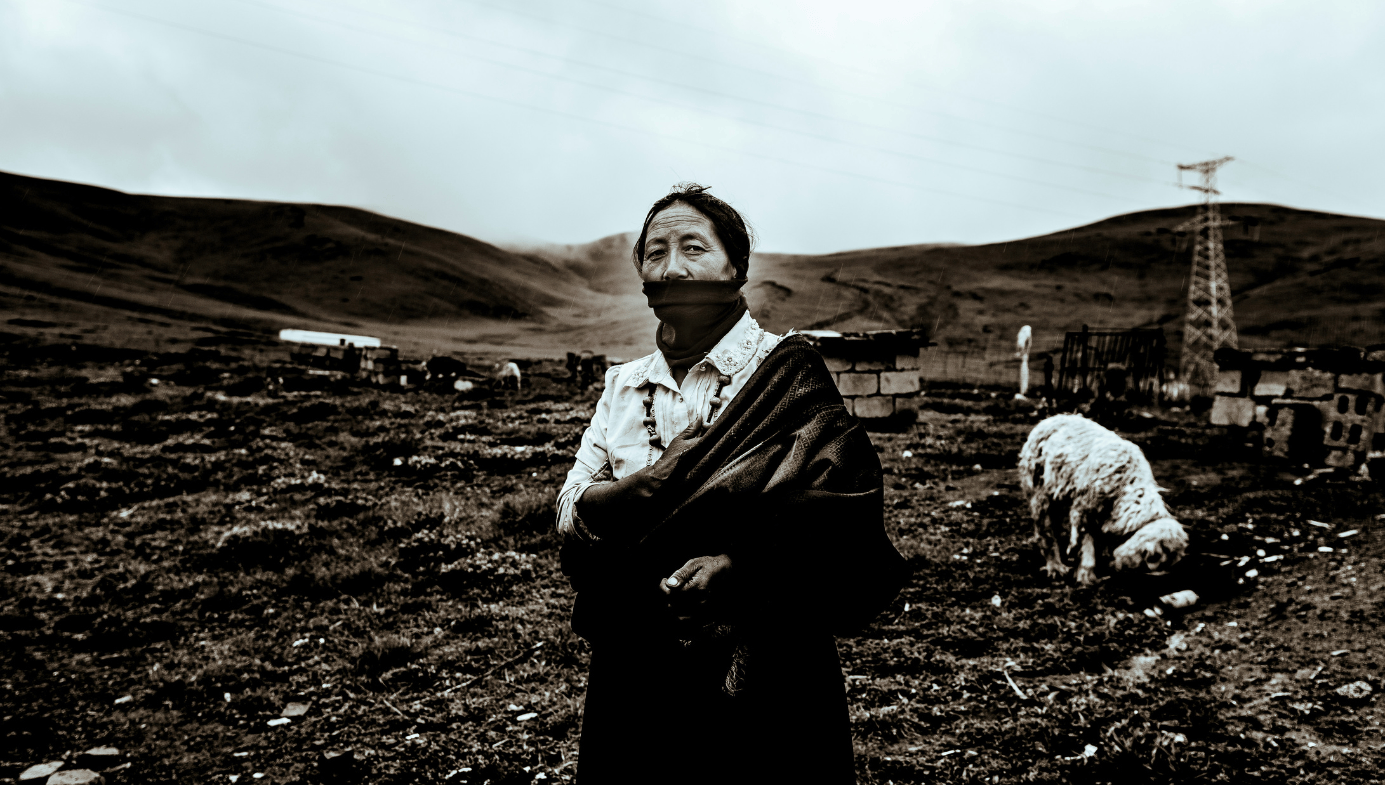 A poor-looking woman in a field in Yushu Tibetan Autonomous Prefecture in Qinghai Province.