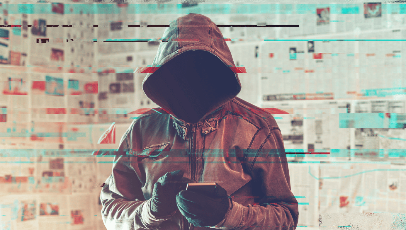 Hooded hacker person using smartphone in infodemic concept with digital glitch effect