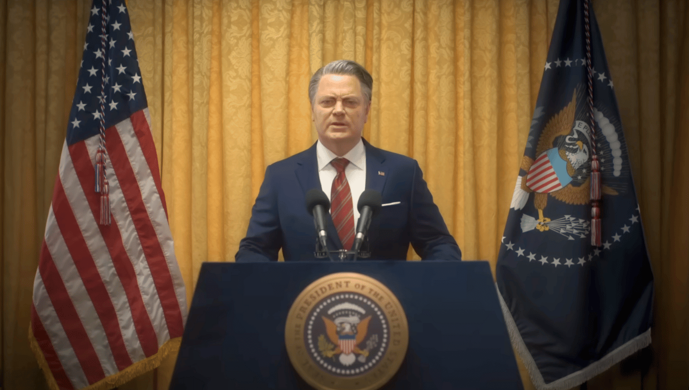 Actor Nick Offerman as the President of the US during a public address. A still from the film.