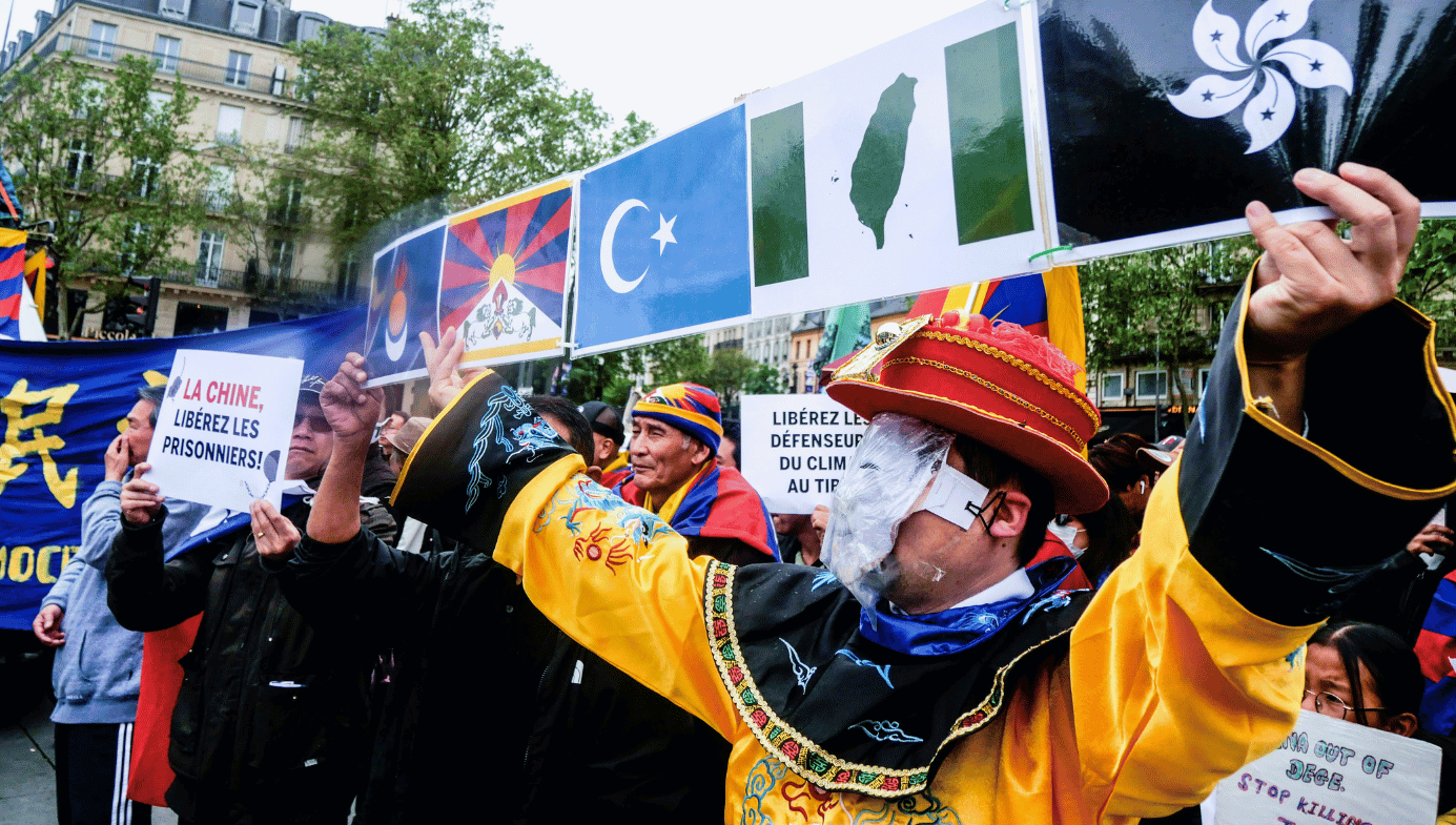 Free Tibet protestors in colourful costumes hold up signs