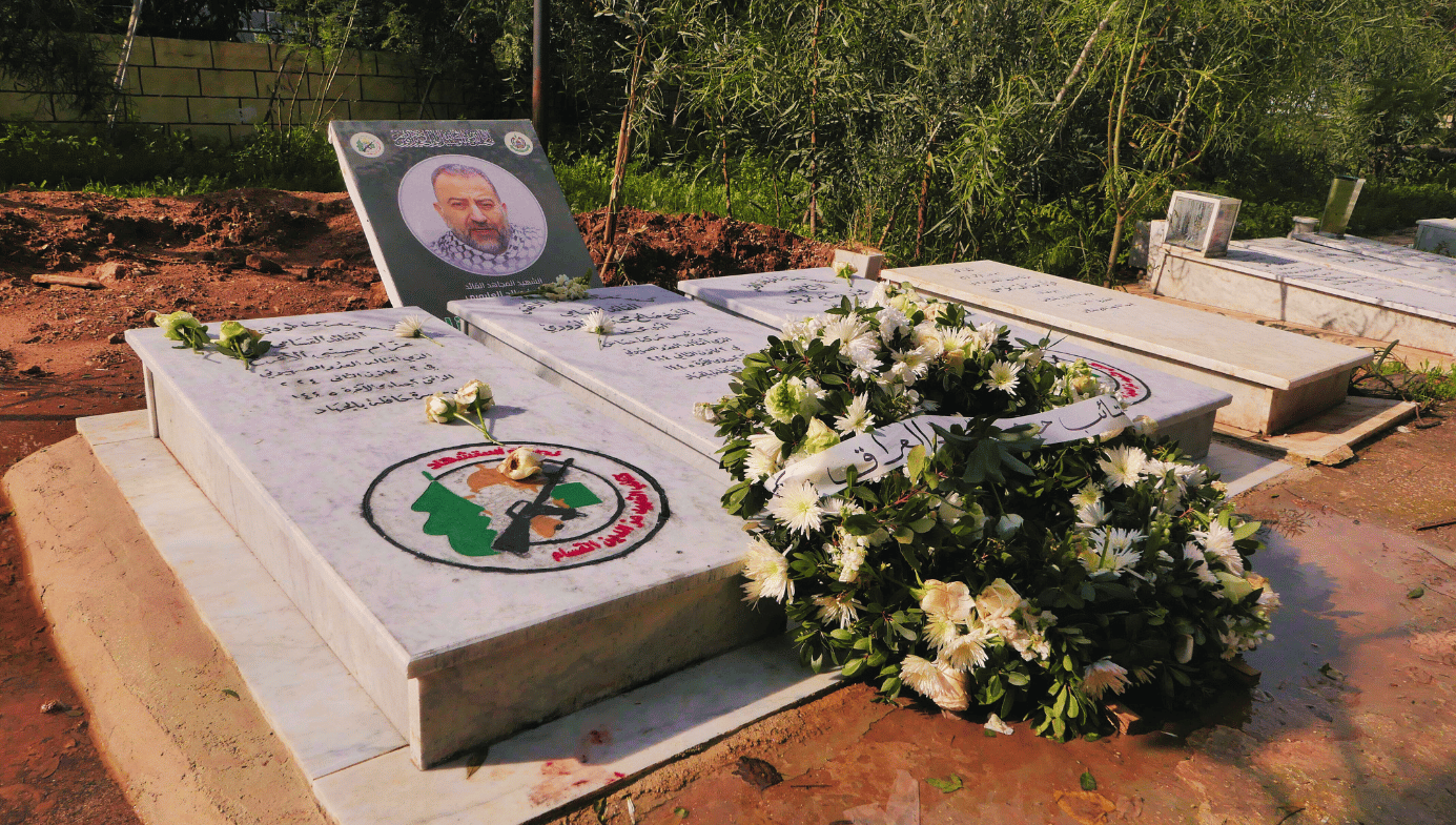 The grave of Hamas’s top political leader Saleh Arouri. Gravestone, flowers, a picture of Arouri. 