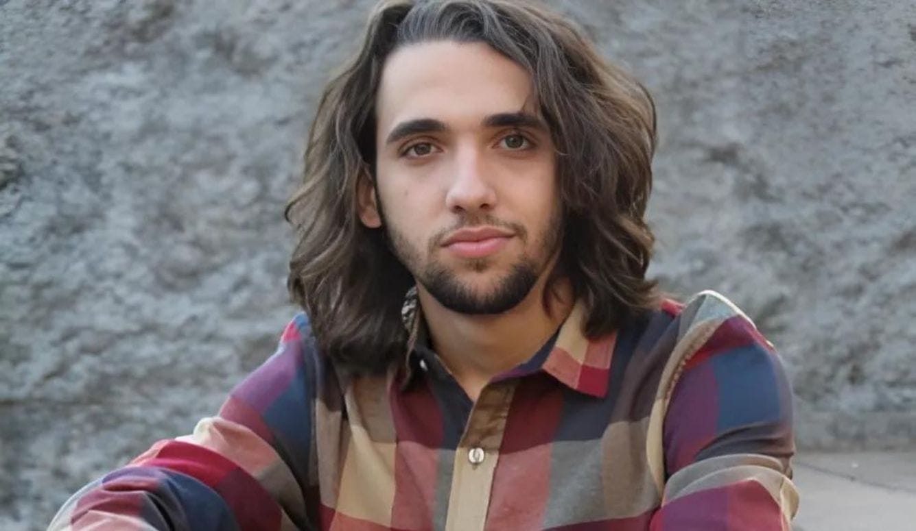 An image of Justo Antonio Triana, a young man (around 20) with shoulder length brown hair and a beard. He is Spanish-looking.