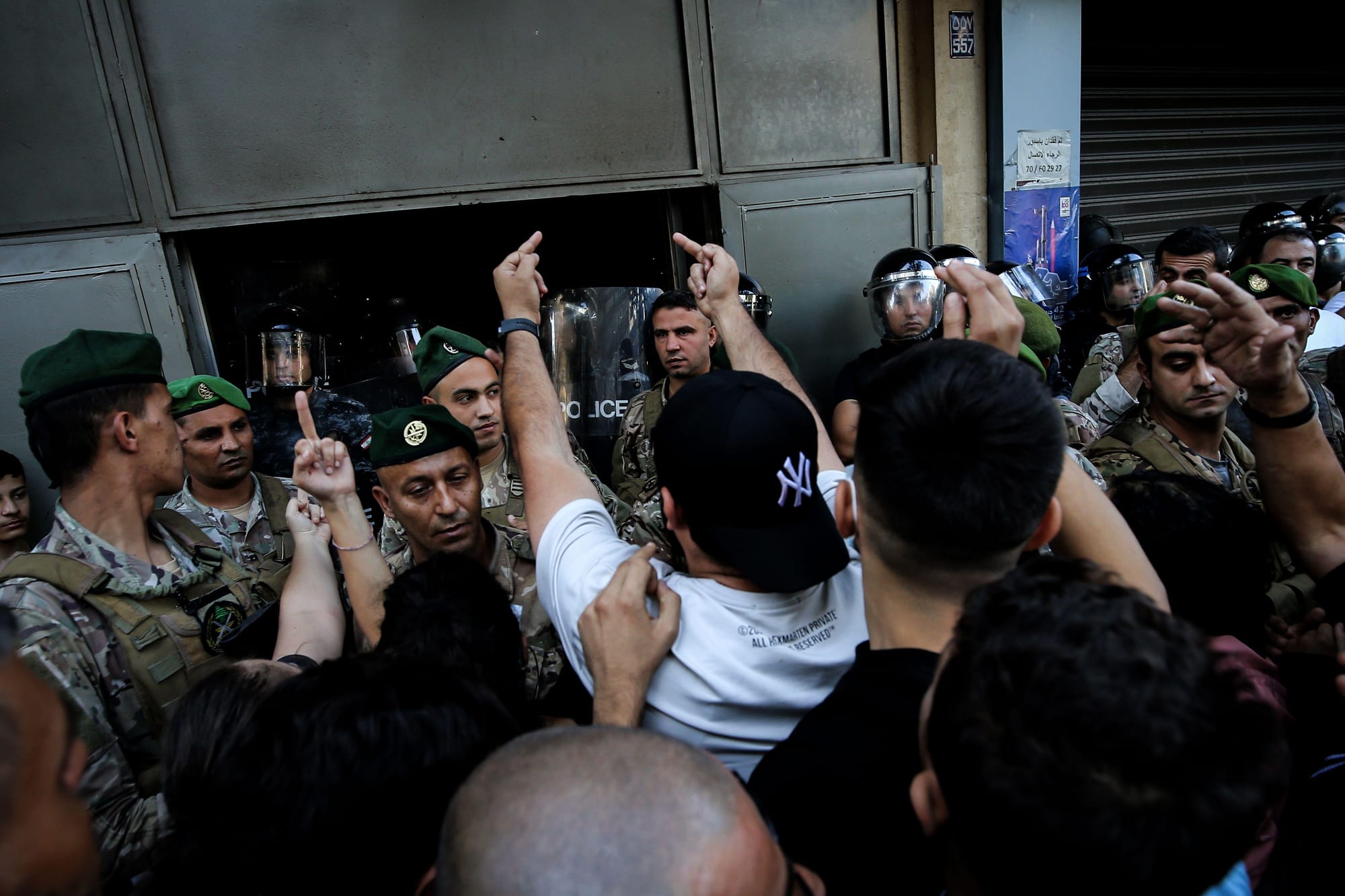 Angry protestors give the middle finger to Lebanese security guards.