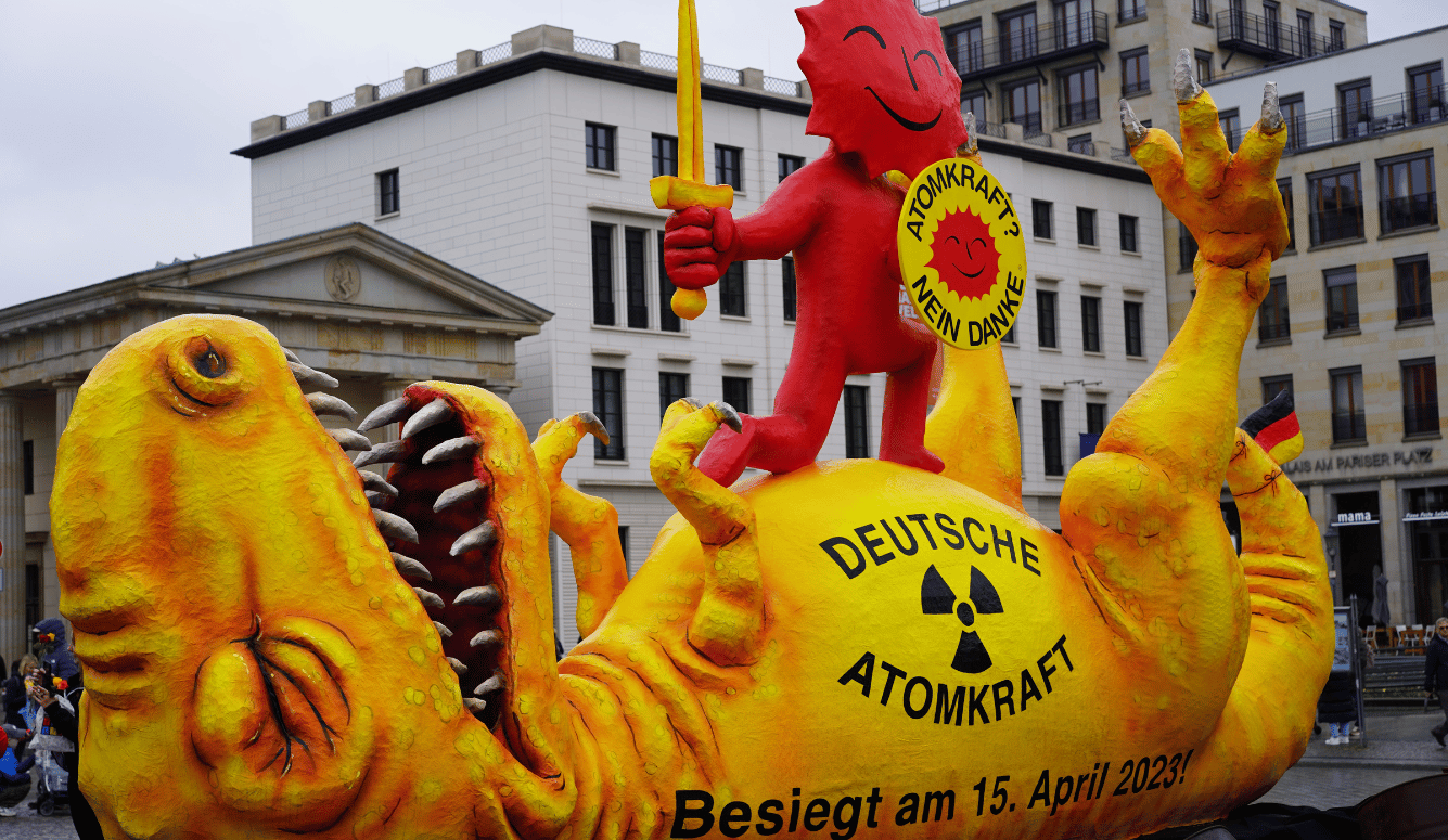 A giant puppet dinosaur is dead, representing the death of Germany's nuclear power plants. 