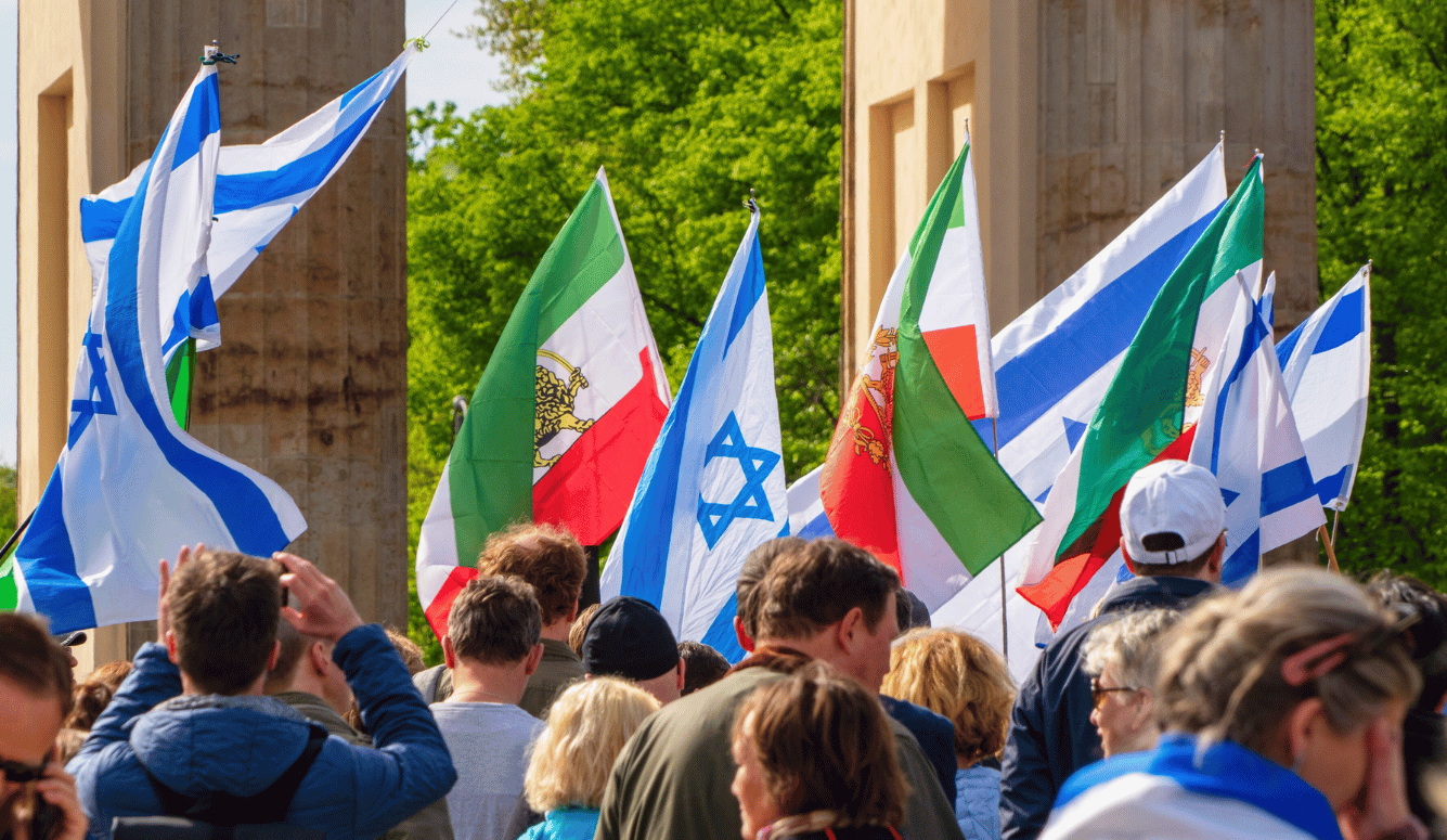 Protestors with Israeli flags and Iranian pre-Islamic flags, with their backs to us. 