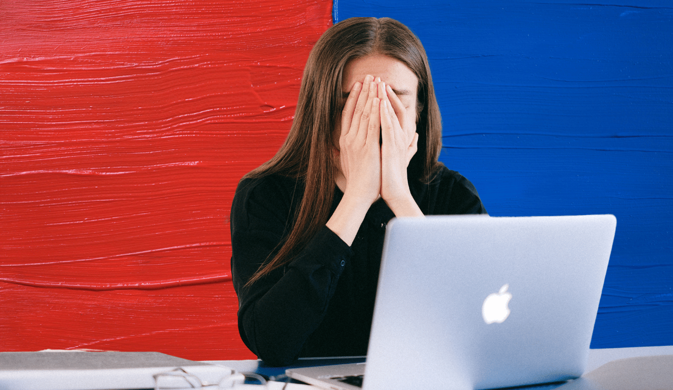 A woman working in front of her laptop looks stress. A binary of red and blue in the backgr