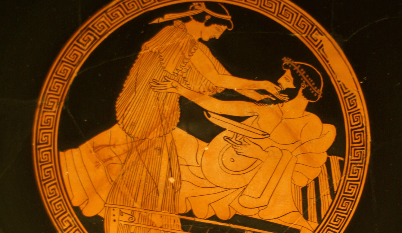 Red figures of a Greek man and woman against a black background. They are drinking and caressing each other.