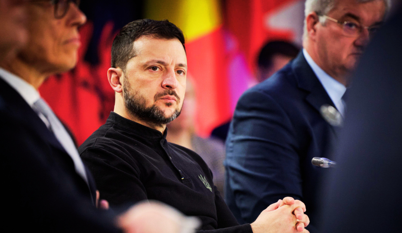 President Zelenskyy in a black shirt, looking concerned. 