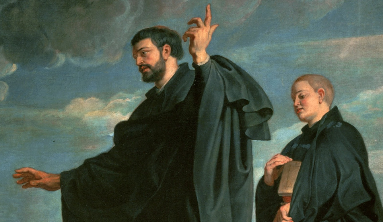 A middle-aged priest in black robes gesticulates at the sky. He is followed by a young assistant carrying a book. 