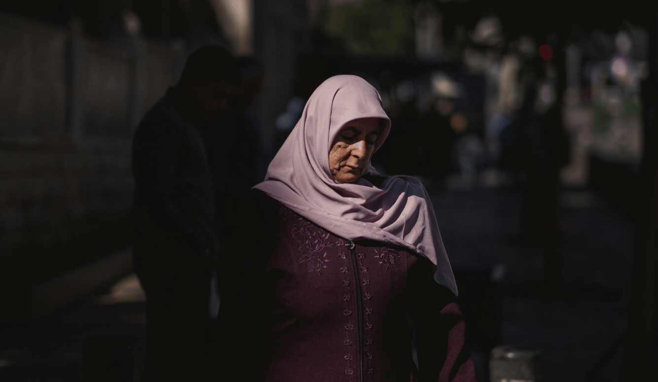 A woman in a hijab walking down the street. 