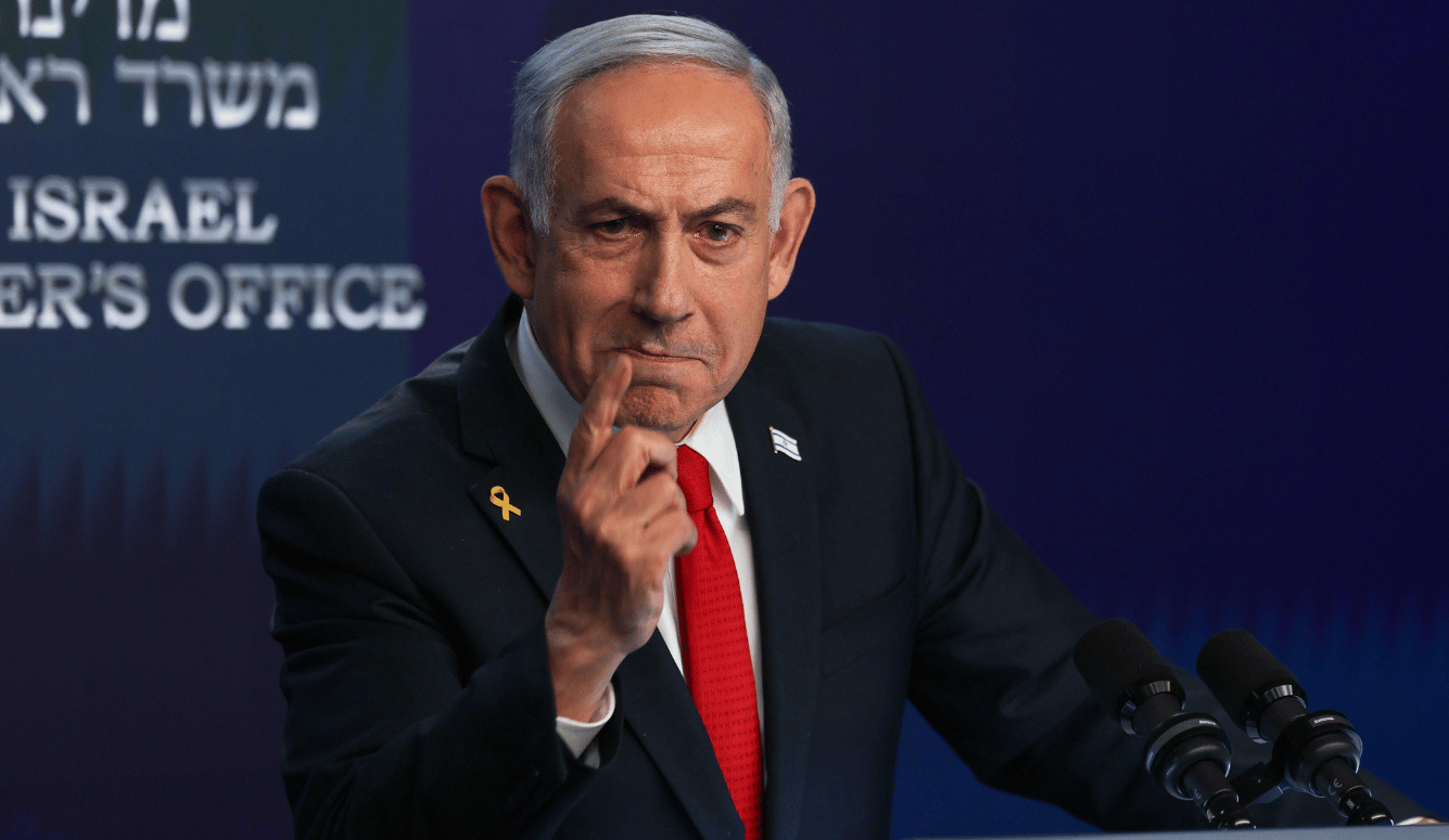 Netanyahu wags a finger, he looks determined and angry.