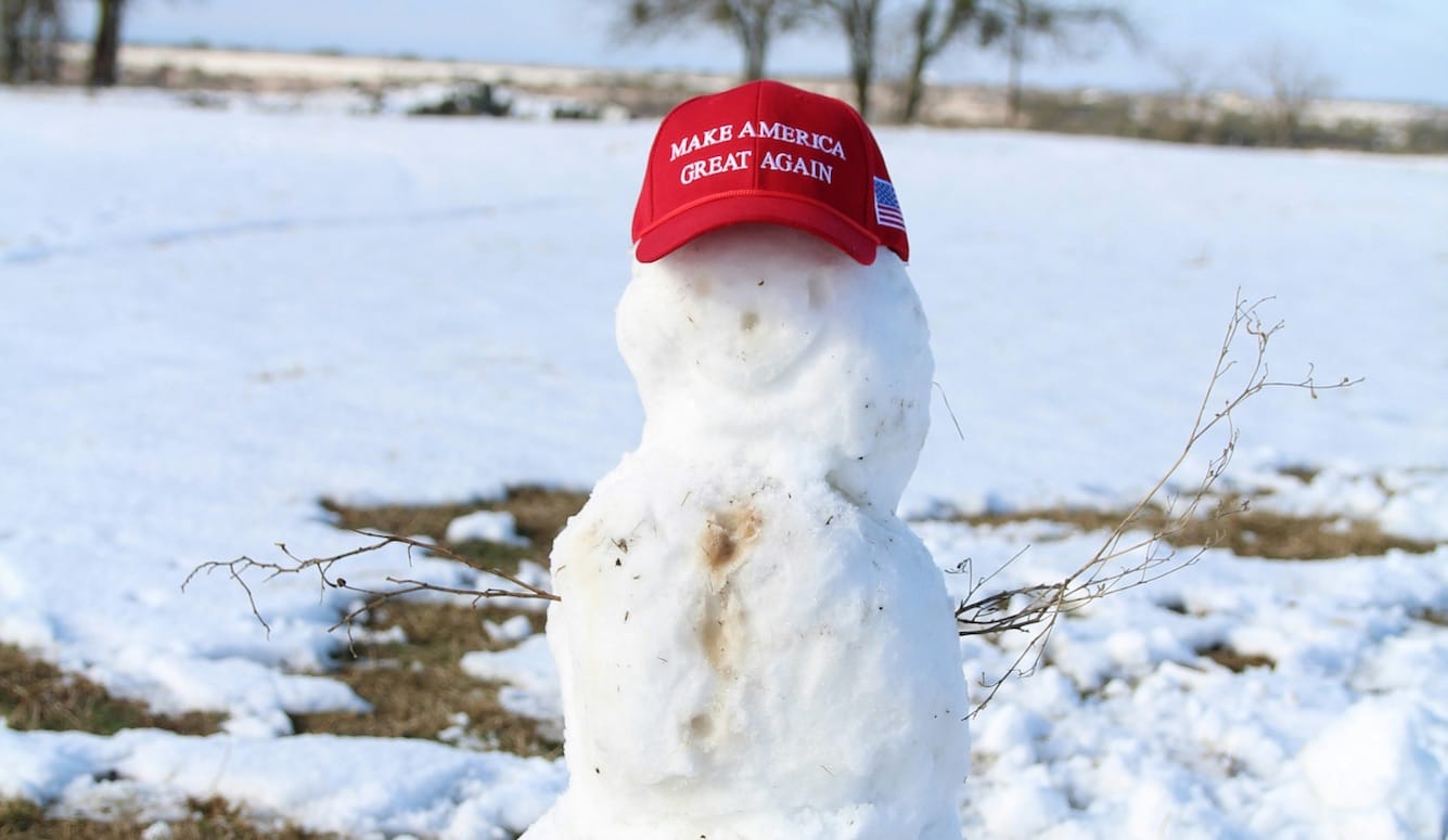 A snowman wearing a red Make America Great Again cap. 