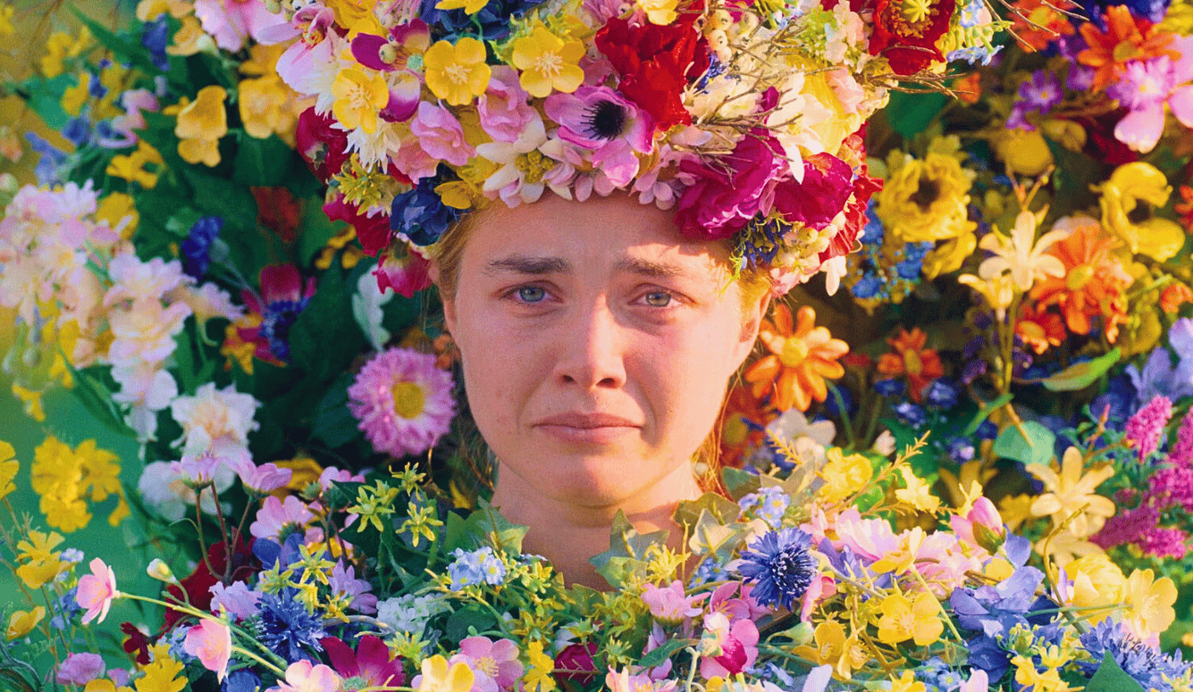 A sad girl in a flower crown, surrounded by bright flowers.