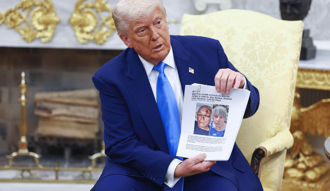 Trump holds up news articles related to violence in South Africa during a meeting with President Cyril Ramaphosa.