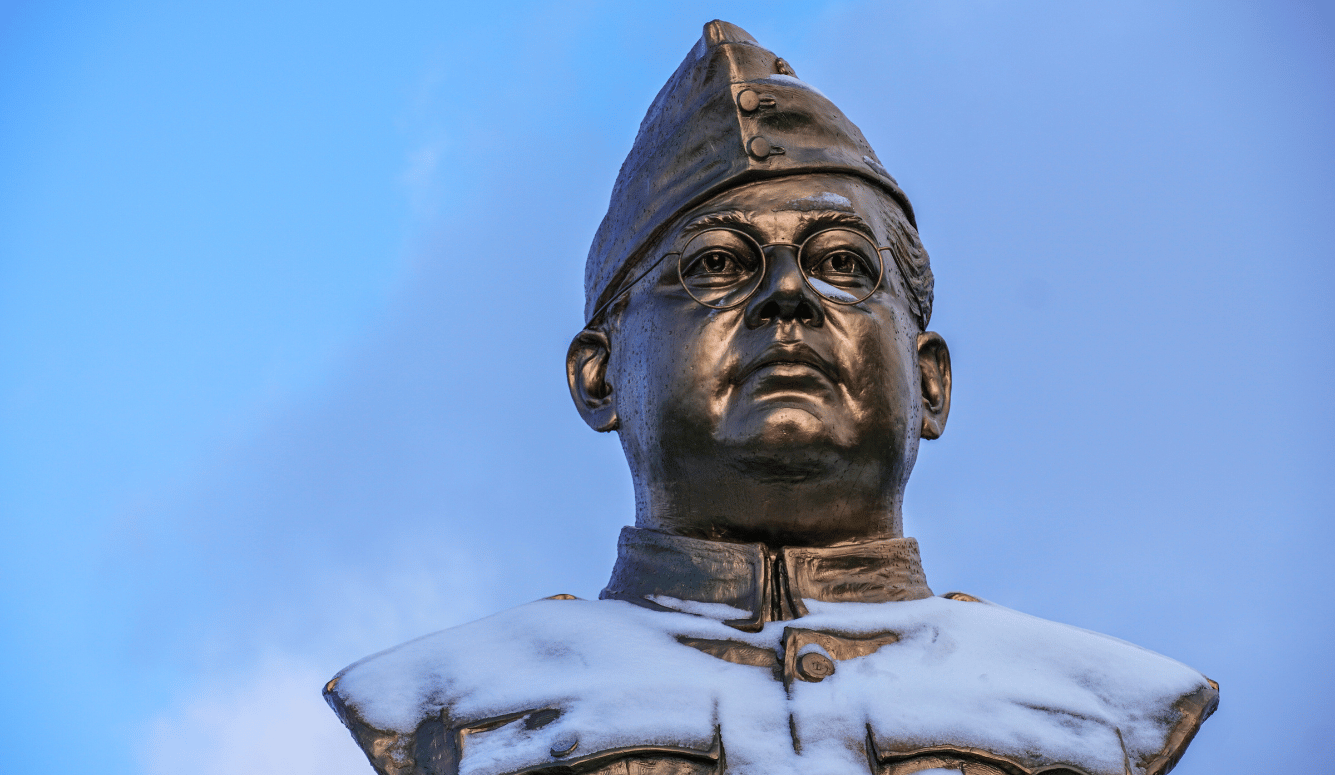 Bronze bust of Subhas Chandra Bose, dusted with snow. 