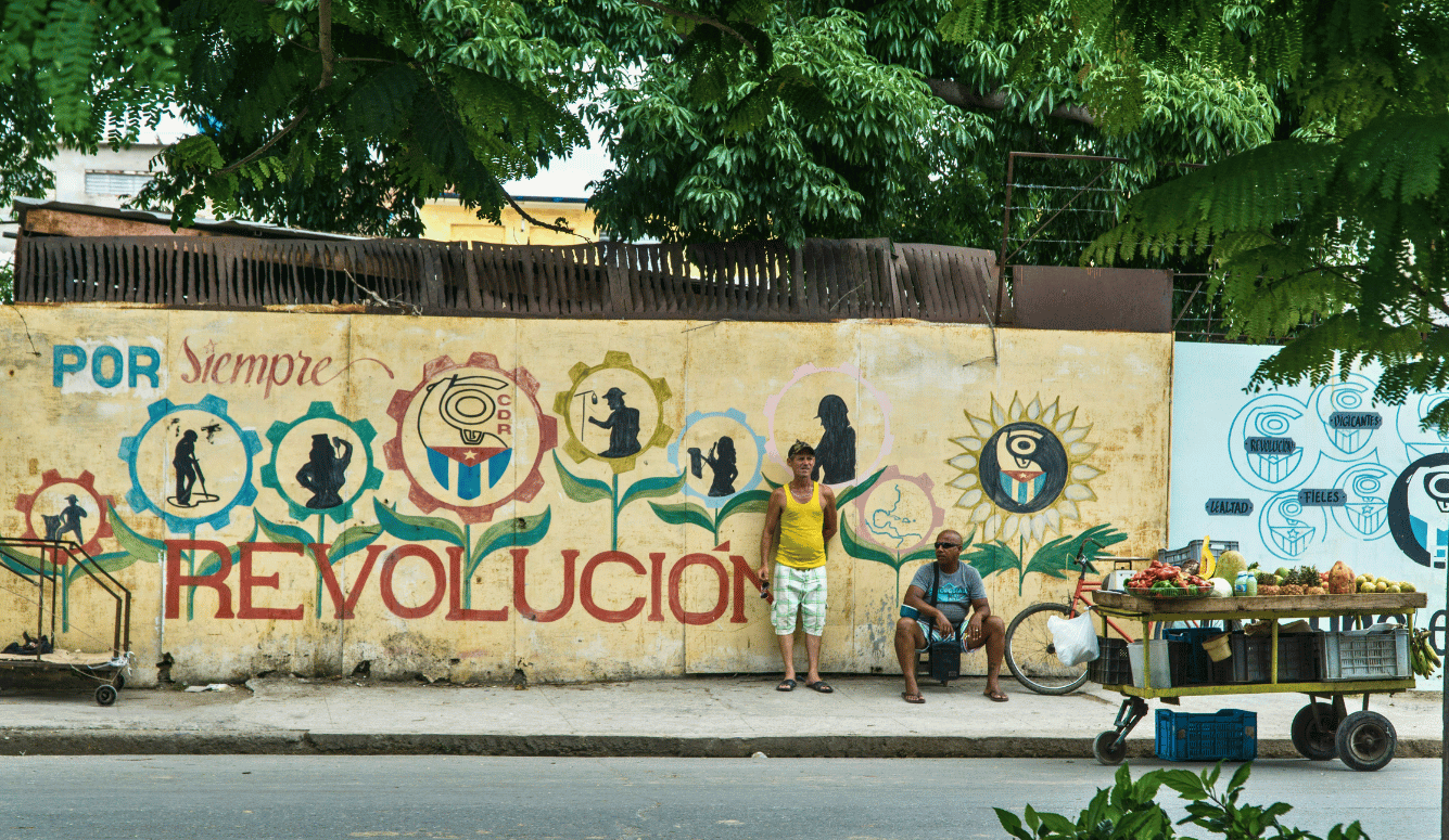 "Revolution Forever" mural in Cienfuegos, Cuba. Two Cuban men and a fruit cart.