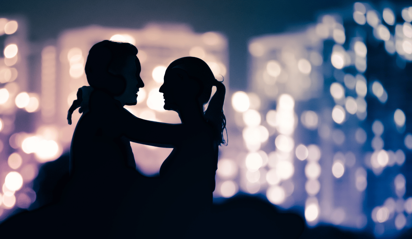 A silhouette of a heterosexual couple with arms around each other.
