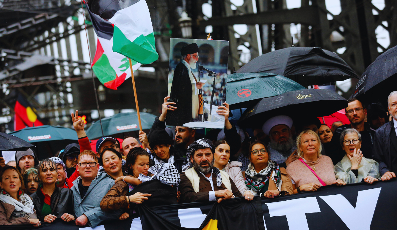 A protester holds up a portrait of  Ali Khamenei while marching across the Sydney Harbour Bridge during the "March for Humanity Save Gaza," rally
