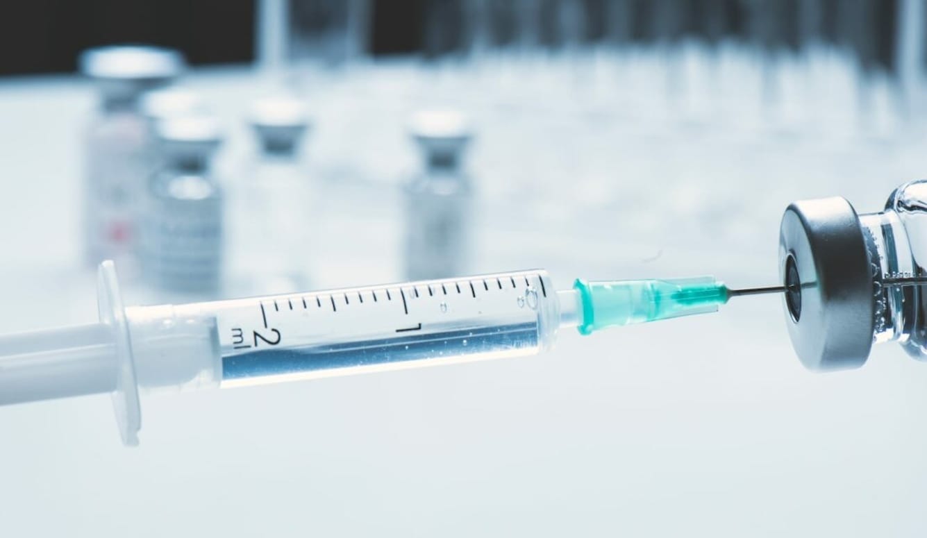 Syringe and bottle of liquid. 