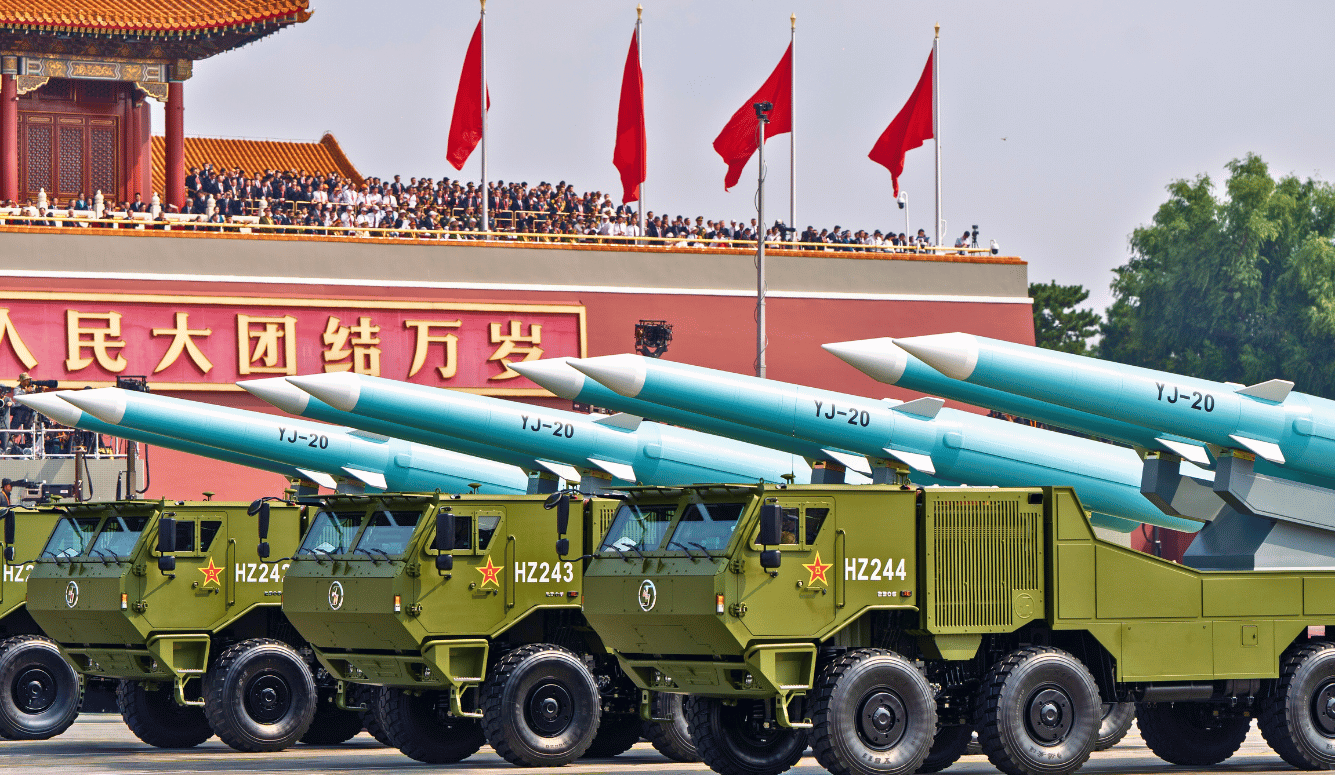 Tanks carrying missiles in Tiananmen Square. Chinese flags in background.