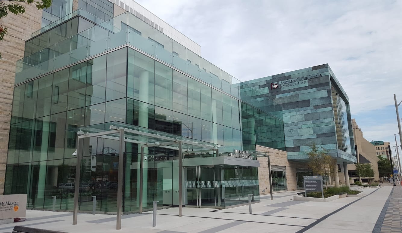 McMaster University campus, a set of a modern glass and stone buildings. 