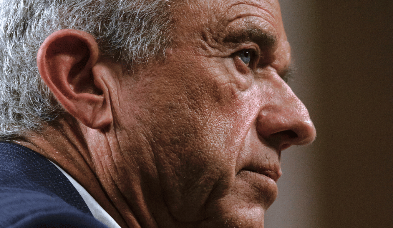 Close up of profile of Robert F. Kennedy Jr., a white man in his sixties or seventies with grey hair and blue eyes.