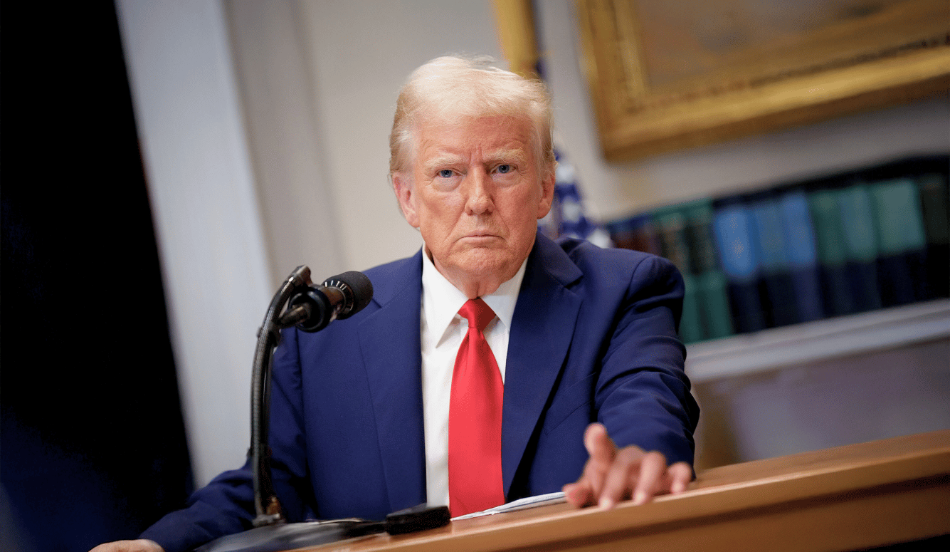 Donald Trump in a blue jacket and red tie. 