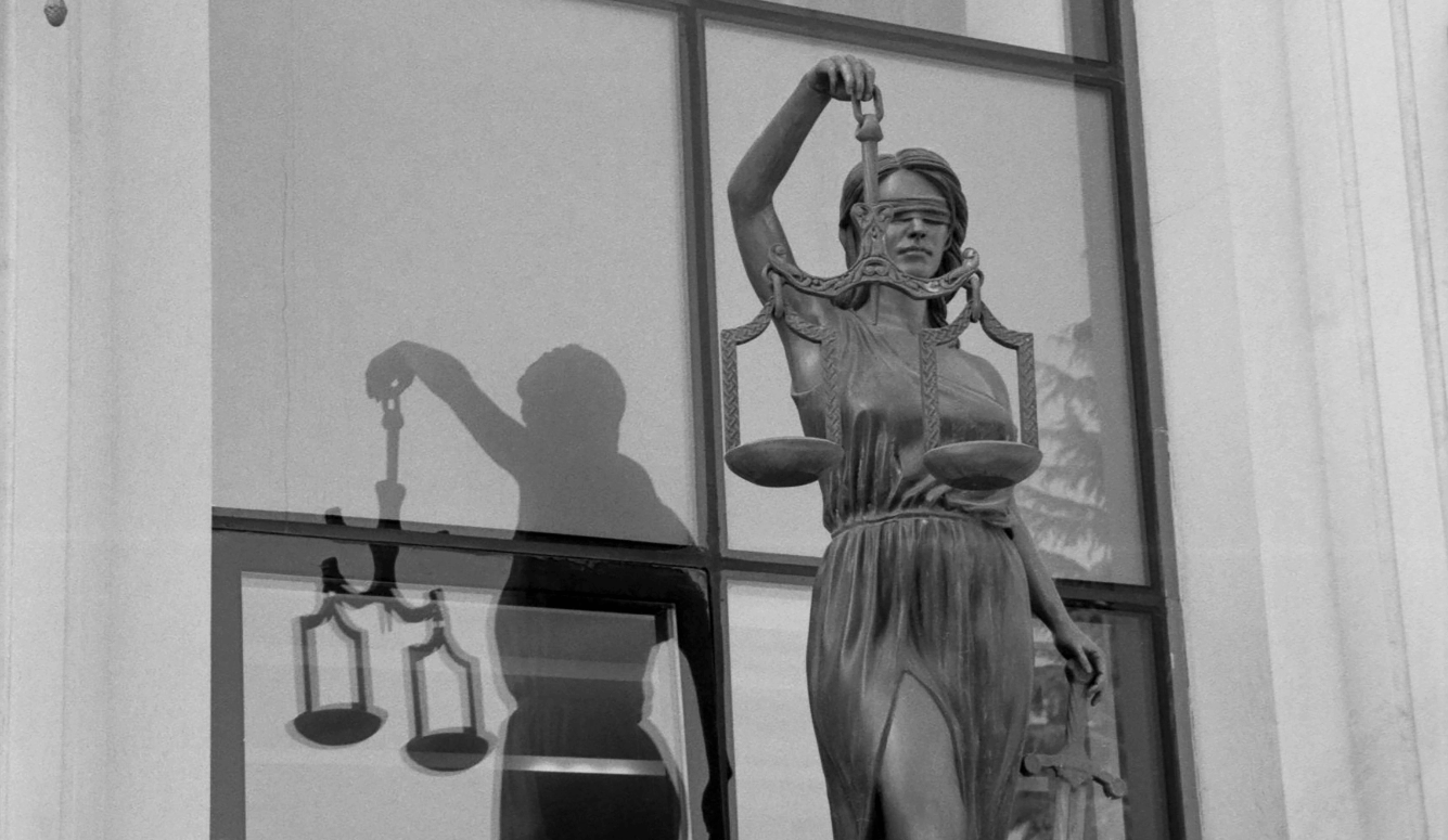 Lady Justice statue in black and white.