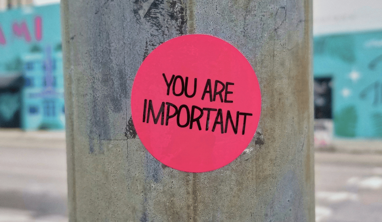 Sticker placed on a pole at the corner of a street. It says "You are important"