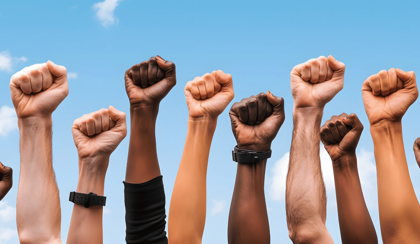 Diverse group of fists raised in protest.