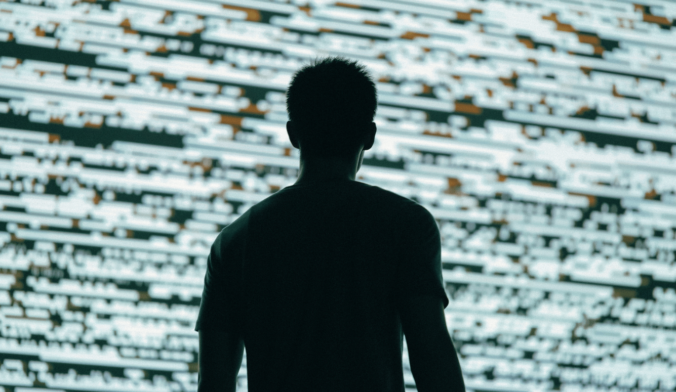 Male silhouette with digital screen background.