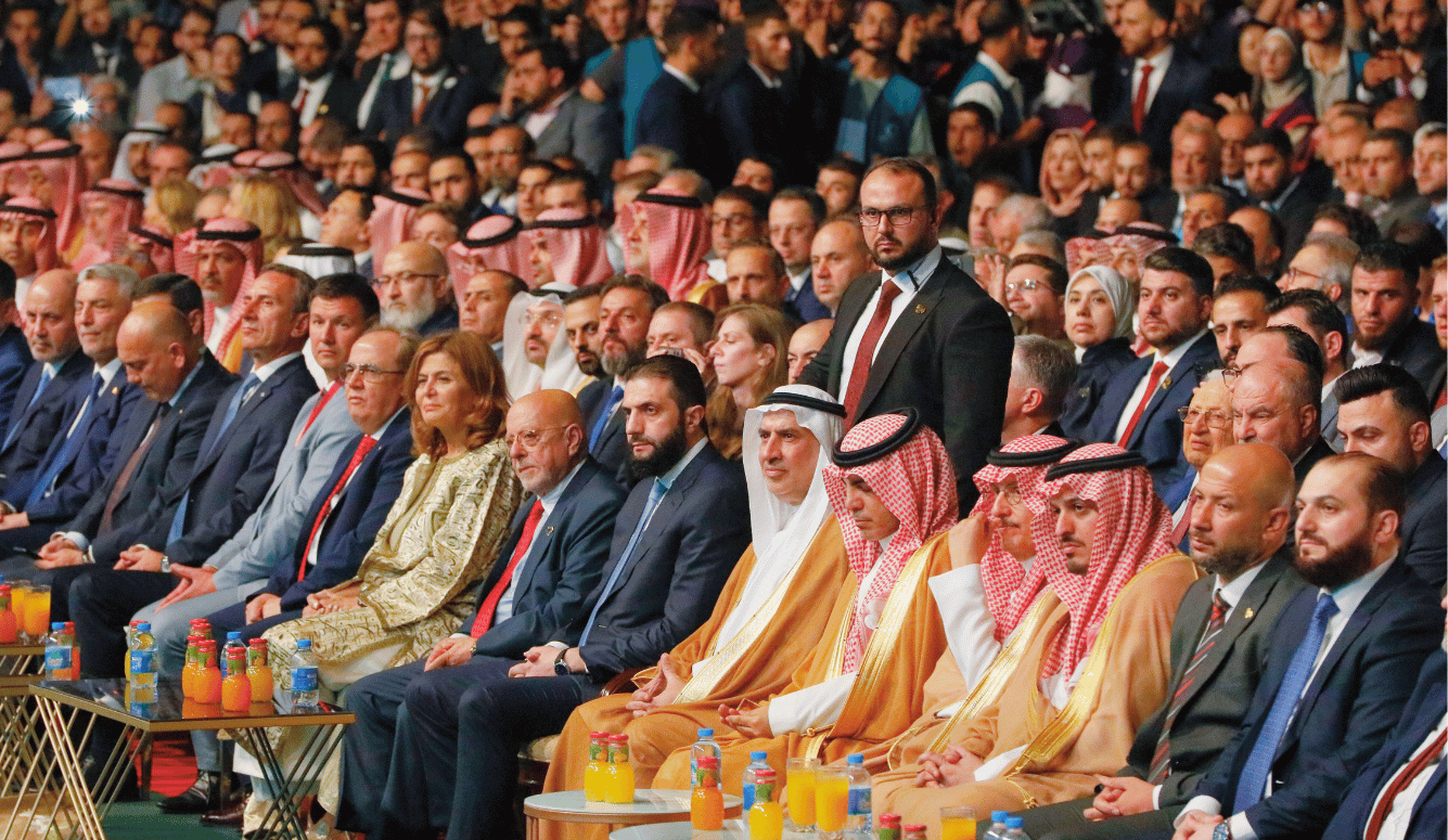 Arab and foreign officials seated in rows at the Damascus International Fair during an opening ceremony in Syria.
