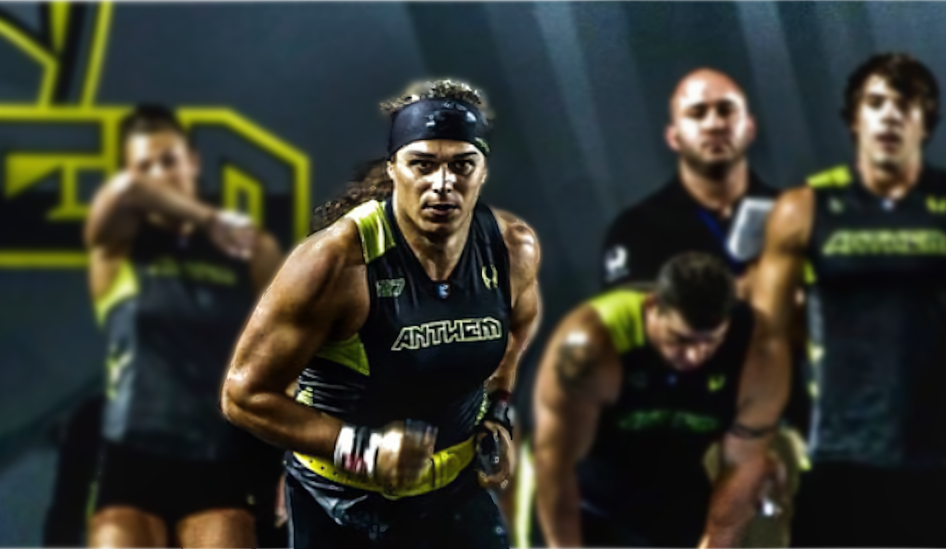Athlete wearing black-and-yellow Anthem gear, with teammates in the background. Lightly blurred and stylised image. 