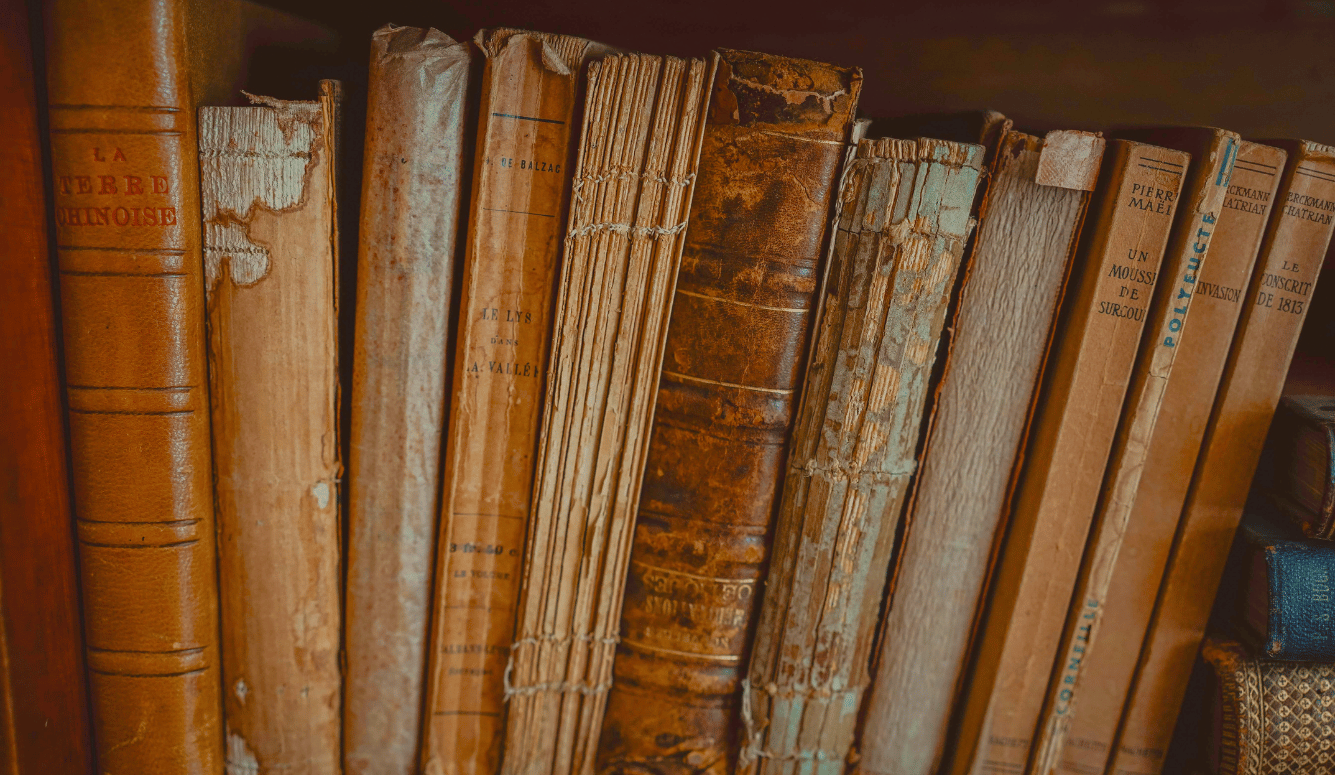 Old books with cracked spines. 