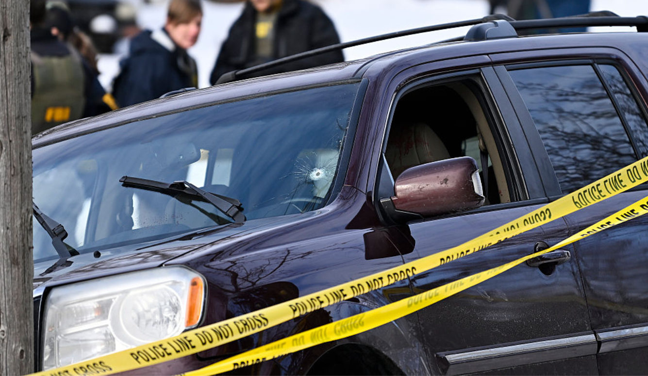 Police tape surrounds a vehicle involved in a fatal shooting