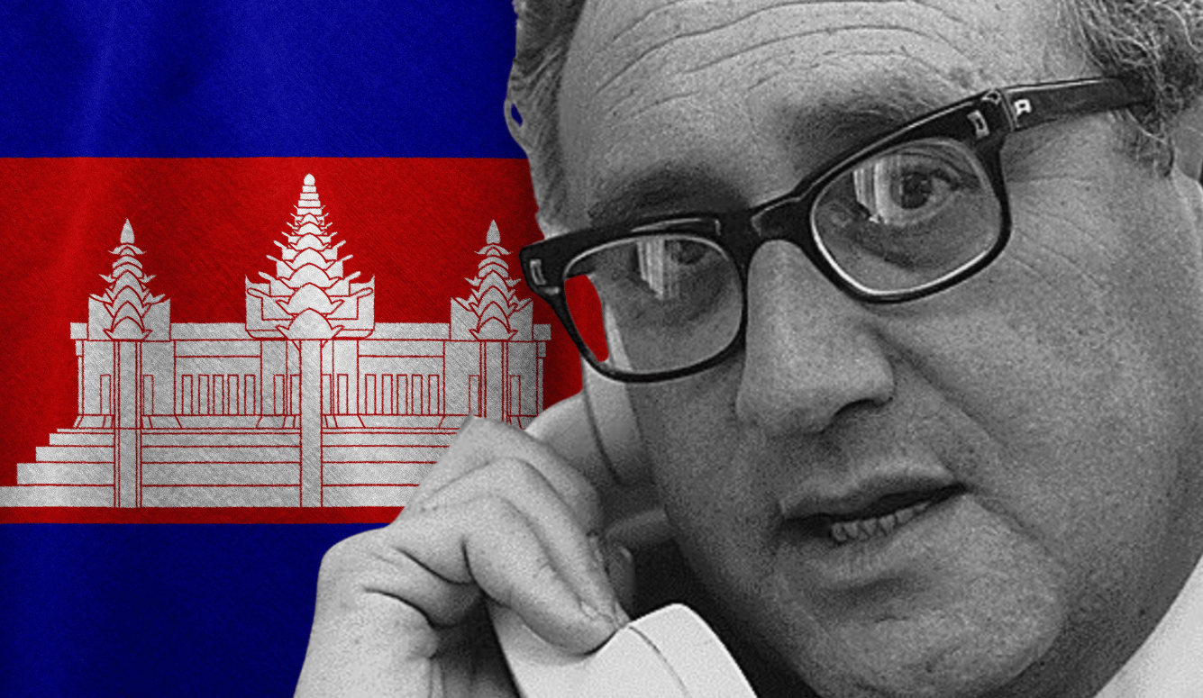 Black-and-white portrait of Henry Kissinger speaking on a telephone beside the Cambodian flag with Angkor Wat emblem.