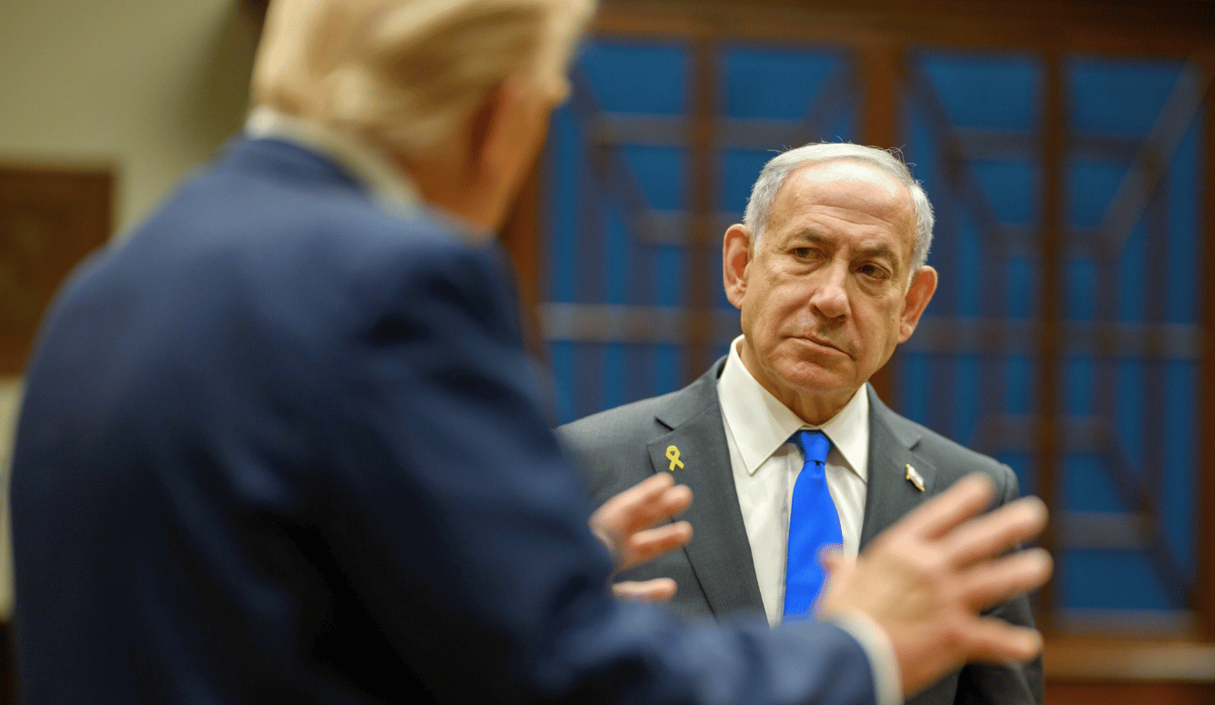 Trump gestures while speaking to Netanyahu, who listens during a meeting.