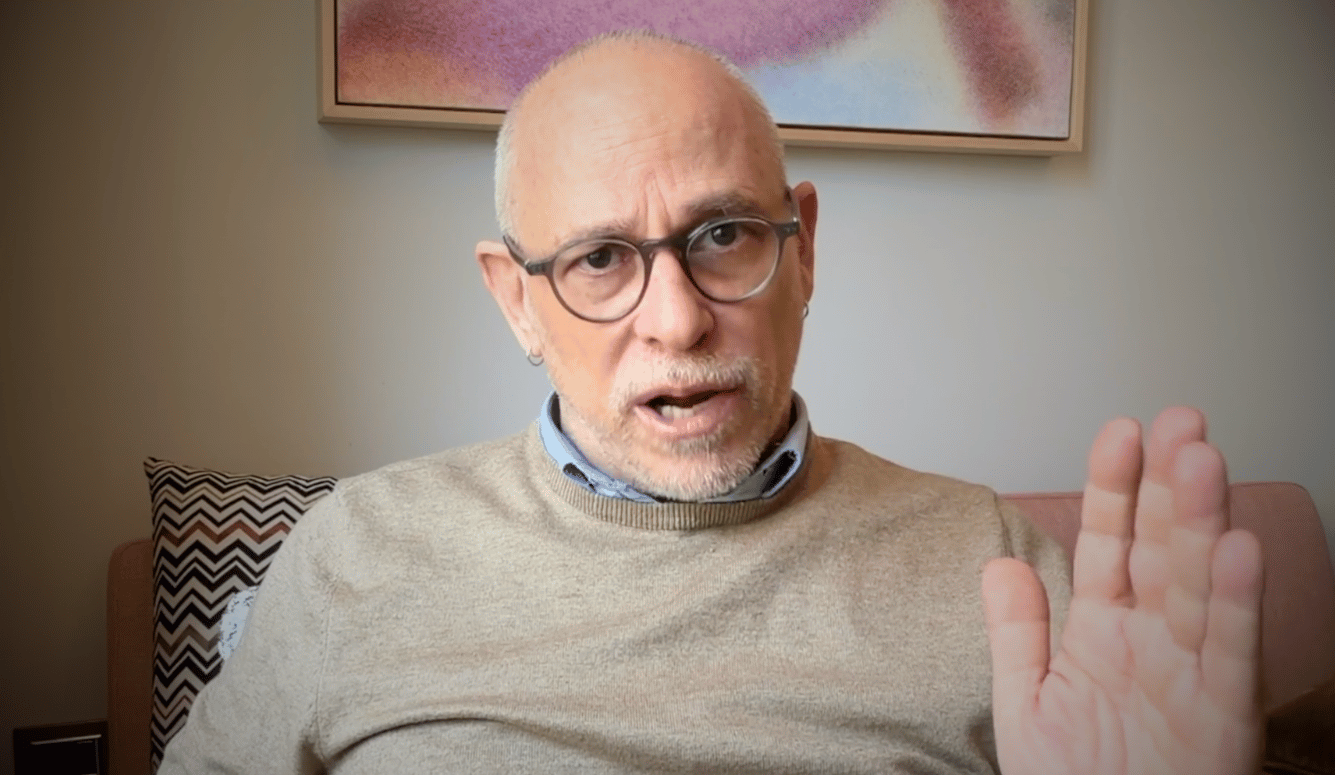 Gadi Taub is a bald man with glasses. He wears a cream sweater.