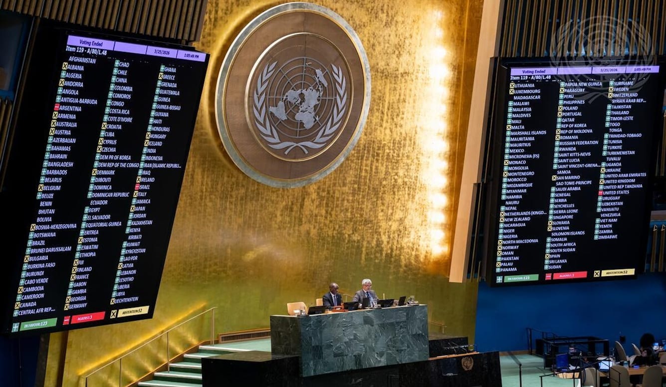 UN General Assembly hall showing voting results for Item 119 A/80/L.48, 25 March 2026: 123 in favour, 3 against, 52 abstentions.