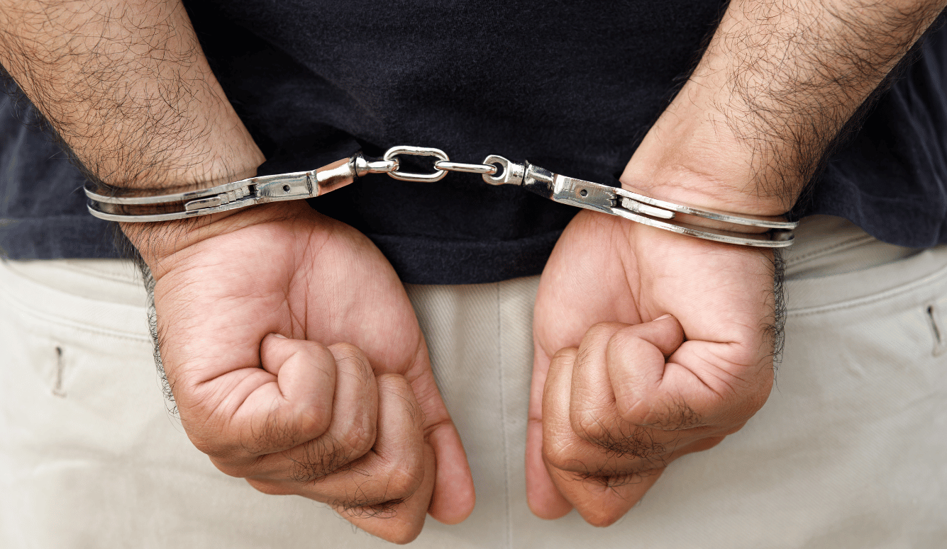 Man's Hands in Handcuffs Closeup