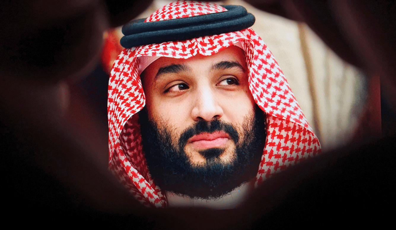 Close-up portrait of Saudi Arabia Crown Prince Mohammed bin Salman (MBS) wearing a traditional red shemagh headdress and robes.