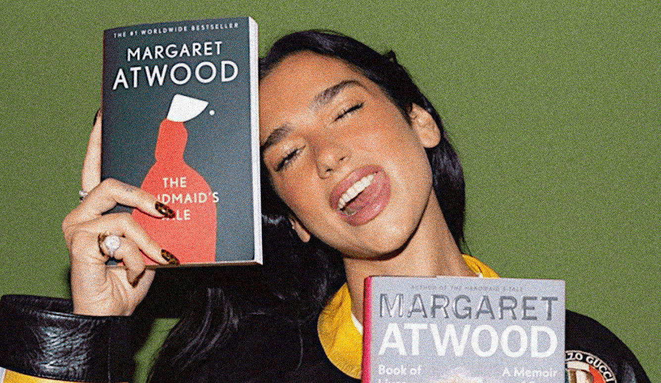Woman with long dark hair holds Margaret Atwood’s The Handmaid’s Tale beside a second Atwood book.