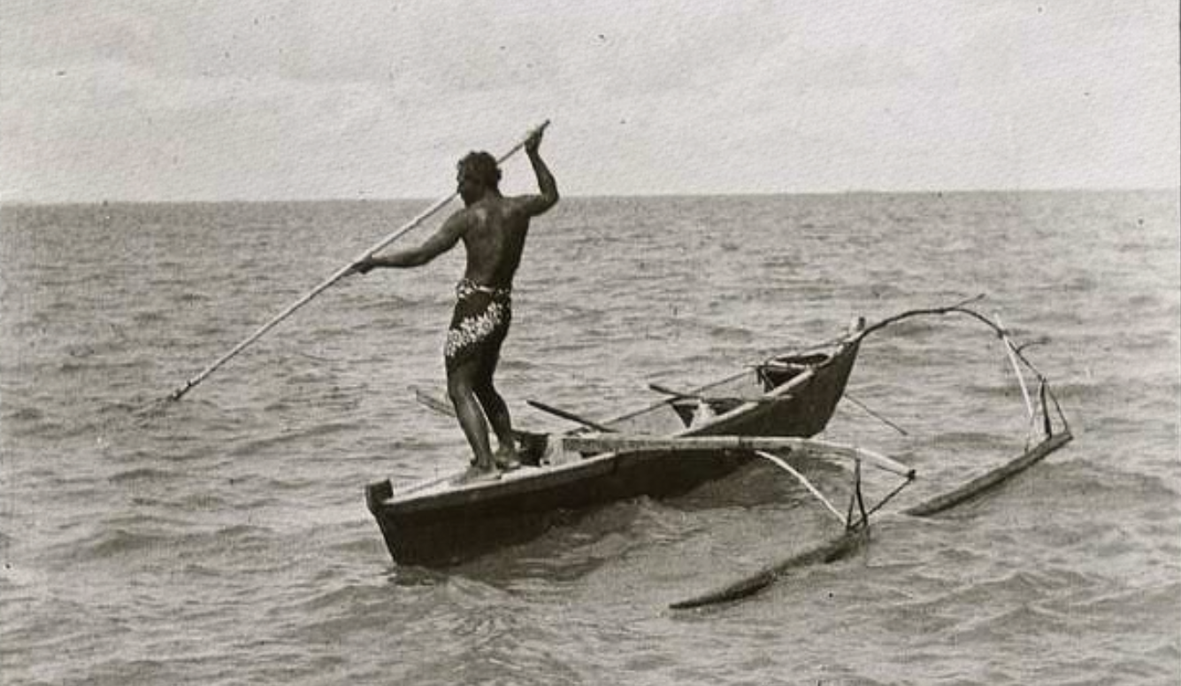 A figure with a spear in a canoe at sea