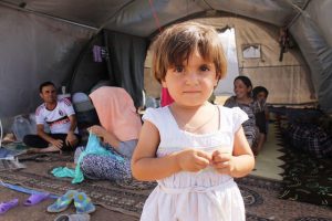 Iraqi refugee girl with her family at Newroz camp